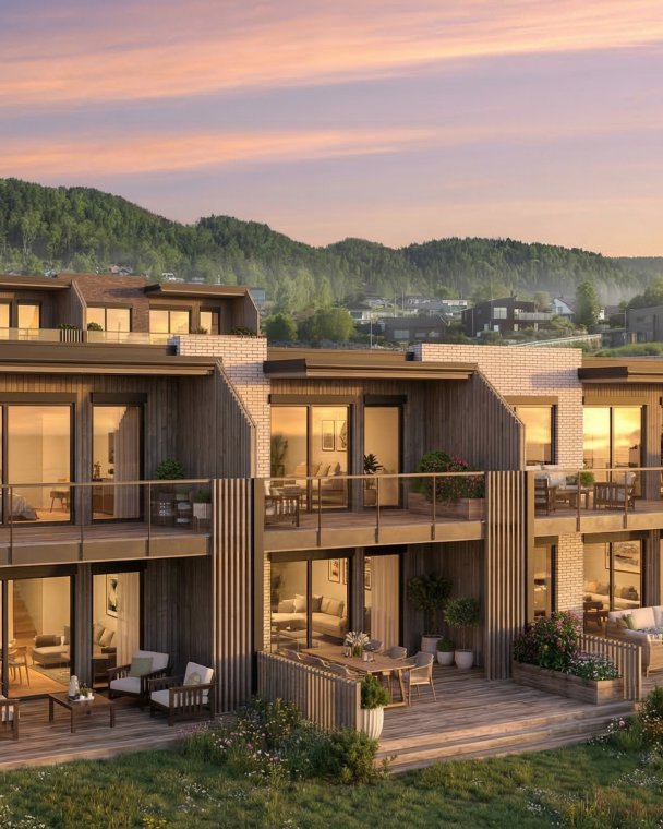 Elegant boligkompleks med store terrasser og panoramautsikt over fjellene.
